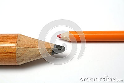 Opposition of a small and greater pencil Stock Photo