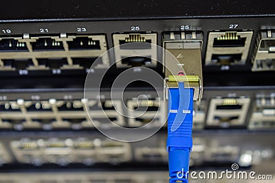 The optical cable is connected to the switch module. Many empty switch ports Stock Photo