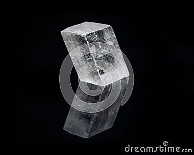 Optical Calcite from China isolated on a black mirror background. Alternative stone name: Iceland Spar Stock Photo