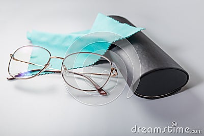 Optical glassesclose up with napkin and case. Reasing glasses on grey background Stock Photo
