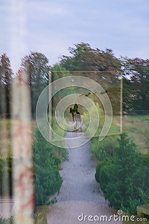 Optical illusion: Painting is reflected in the room window Stock Photo