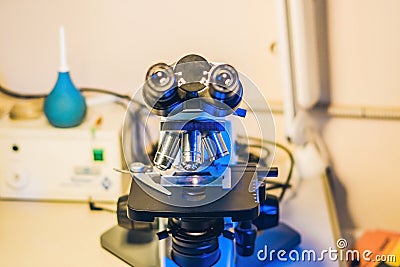 Optical microscope with four different objective lenses Stock Photo