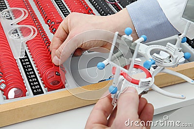 Optician hands choose lenses, trial frame box Stock Photo