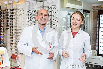 Opticians near stand with spectacles Stock Photo