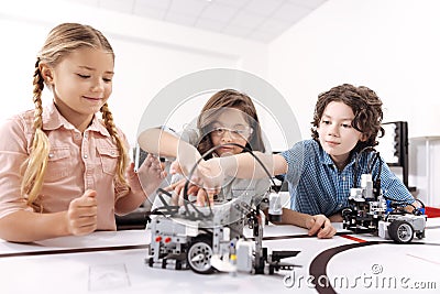 Optimistic children working on the tech project at school Stock Photo