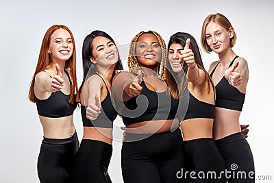 optimistic diverse models showing thumbs up Stock Photo