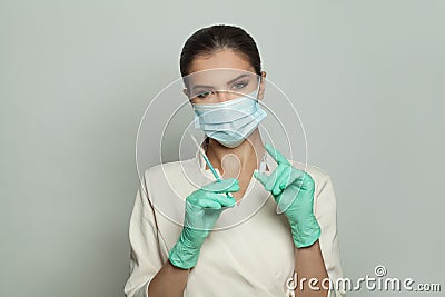 Optimistic doctor woman holding ampoule injecting and syringe on white. Medicine, cosmetology and vaccination concept Stock Photo