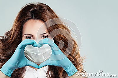 Optimistic doctor woman showing heart. Help, support, healthy lifestyle, healthcare, medicine and ambulance concept Stock Photo