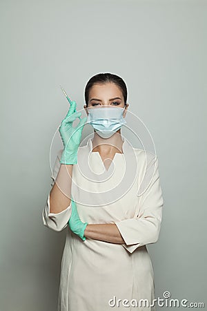 Optimistic doctor woman with syringe on white. Medicine, cosmetology and vaccination concept Stock Photo