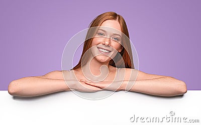 Happy redhead woman with empty white banner Stock Photo