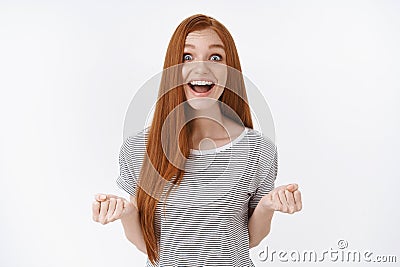 Optimistic happy excited redhead cute teenage girl blue eyes smiling delighted receive awesome opportunity chance good Stock Photo