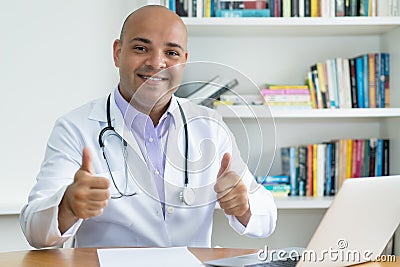 Optimistic medical scientist or doctor with bald working at computer Stock Photo