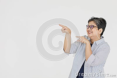 Merry Asian woman pointing away Stock Photo