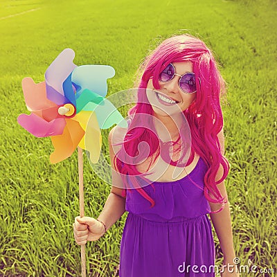 Optimistic young woman wearing pink wig Stock Photo