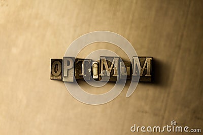 OPTIMUM - close-up of grungy vintage typeset word on metal backdrop Stock Photo