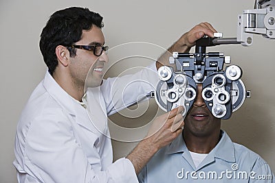 An Optometrist Adjusting Panels Of Phoropter Stock Photo