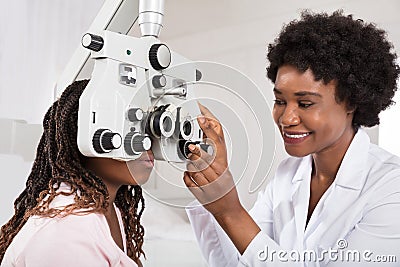 Optometrist Doing Sight Testing For Patient Stock Photo