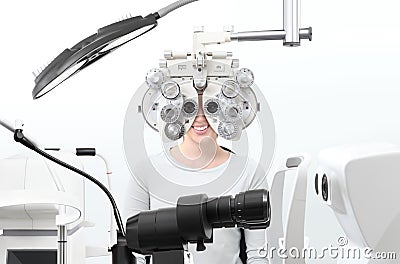 Optometrist exam, eyesight woman patient with phoropter in opti Stock Photo
