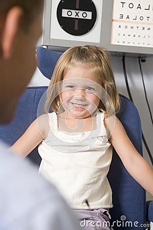 Optometrist in exam room with young girl Stock Photo