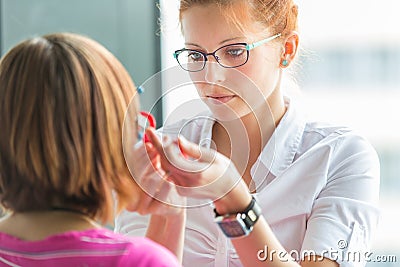 Optometry concept - pretty, young female optometrist Stock Photo