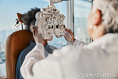 Optometry, healthcare and optometrist doing a eye test for a patient for vision or eyecare in a clinic. Ophthalmology Stock Photo