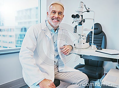 Optometry, healthcare and portrait of a male optometrist sitting by equipment in a optical clinic. Vision, medical and Stock Photo