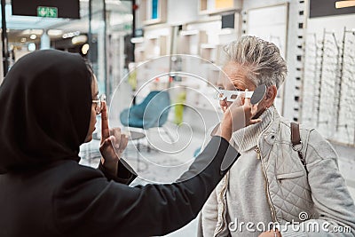 Optometry, Islamic woman and customer in store, glasses and healthcare for vision, retail an testing. Optometrist Stock Photo