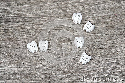 Oral health icon - cute healthy and crying decayed teeth on wood Stock Photo