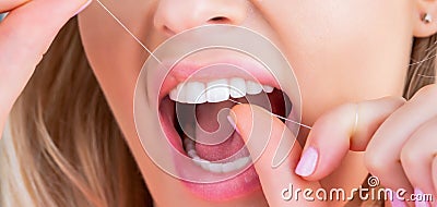 Oral hygiene and health care. Smiling women use dental floss white healthy teeth. Dental flush - woman flossing teeth Stock Photo