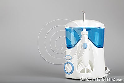 Oral irrigator on a gray background. Stock Photo