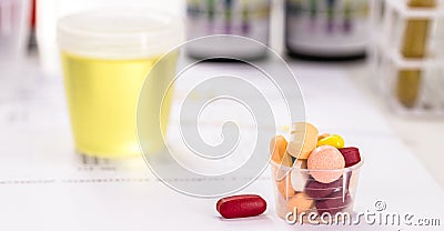 Oral pills for urinary tract infection problems, lab tests and bottles with urine collected in the background Stock Photo