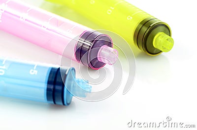 Oral syringe. Syrup medication syringe in pastel color. Stock Photo