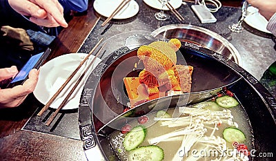 Orande melting piece of fat shaped as bear figure in steel hot d Stock Photo