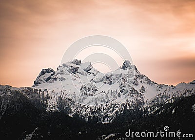 Orange alpen glow behind Sky Pilot Mountain in British Columbia Stock Photo