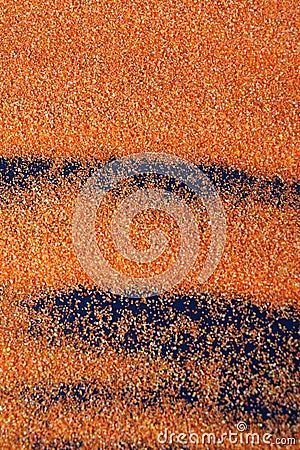Orange artificial sand on black table for background Stock Photo