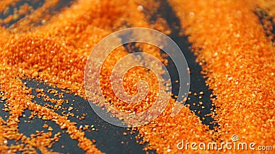 Orange artificial sand for sand therapy on a black table Stock Photo