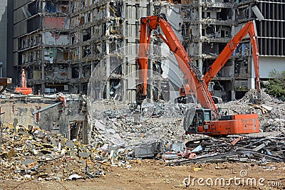 Orange Backhoes Demolish Building Stock Photo