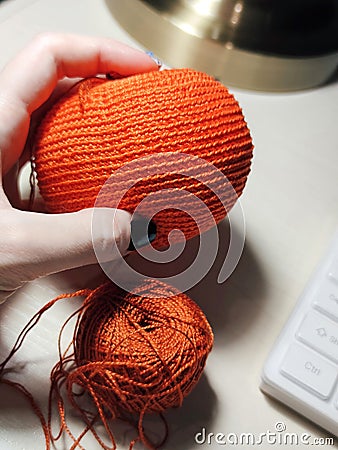 Orange ball process knitting crochet cotton yarn thread hook craft creative closeup macro photo Stock Photo