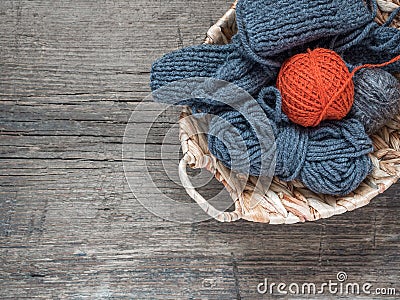 The orange ball of wool yarn and blue yarn in a wicker basket Stock Photo