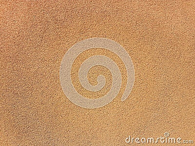 Orange or beige embossed text. The background is a concrete wall of sand color. Stock Photo