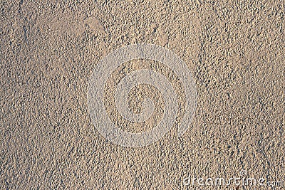 Orange or beige embossed text. The background is a concrete wall of sand color. Texture of a fragment of a wall of a modern Stock Photo