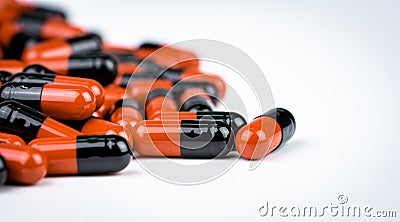 Orange-black capsule pills. Antibiotics drug resistance. Drug use with reasonable. Antimicrobial capsule pills. Pharmaceutical Stock Photo