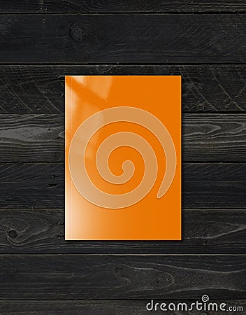 Orange Booklet cover template on black wood background Stock Photo