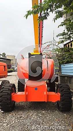 Orange boom Lift 24 meters articulate front view Stock Photo