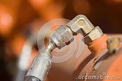 Orange Hydraulic Cylinder Hose Line and Fittings Stock Photo