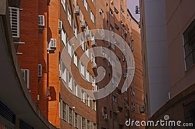 Orange brick building with concave wall Stock Photo