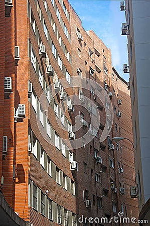 Orange brick building with concave wall, vertical view Stock Photo