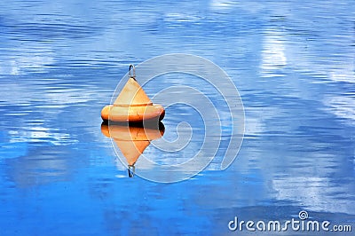 Orange buoy floating on water Stock Photo