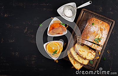 Orange cake with dried apricots and powdered sugar. Stock Photo