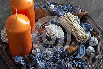 Orange candles with potpourri on an antique metal tray Stock Photo